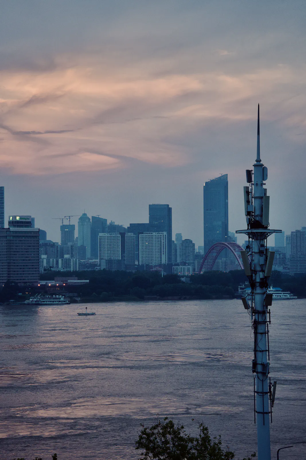 The river and distant skyline under a soft pink sunset.